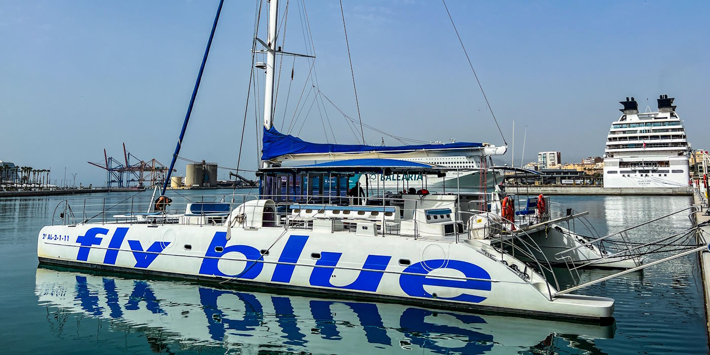 S46A6P Fly blue catamaran boat in Malaga bay in Spain